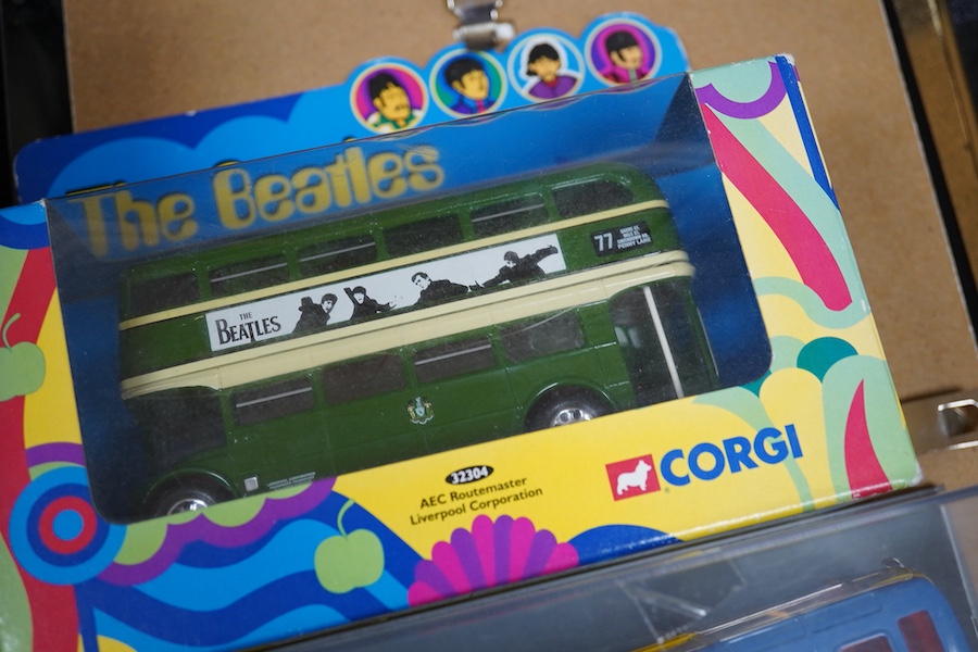 A collection of Beatles memorabilia including; models of a Beatles drum kit and eight miniature guitars and stands, each approx 25cm long, together with three boxed Corgi Beatles related models, including the Yellow Subm